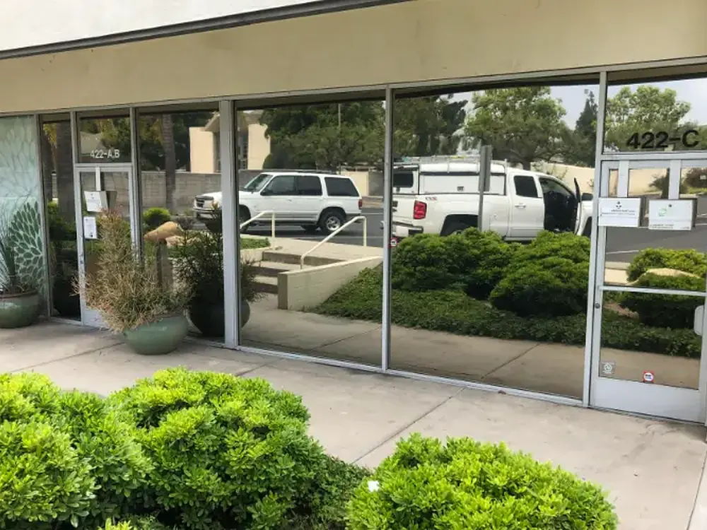 A commercial frontage refilmed with reflective solar film for heat and privacy.